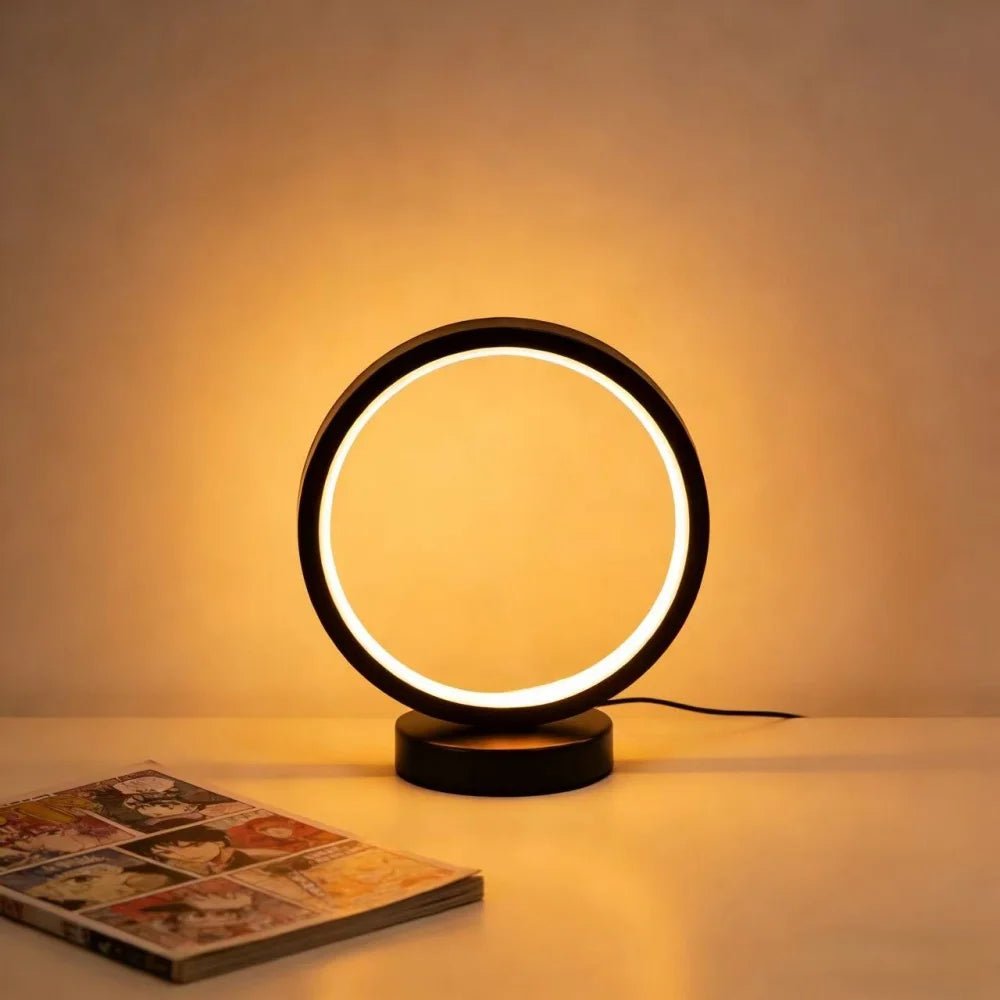 Glow & Drift Eclipse Minimalist Halo Lamp front view showing the smooth circular shadeless LED ring light on a white table