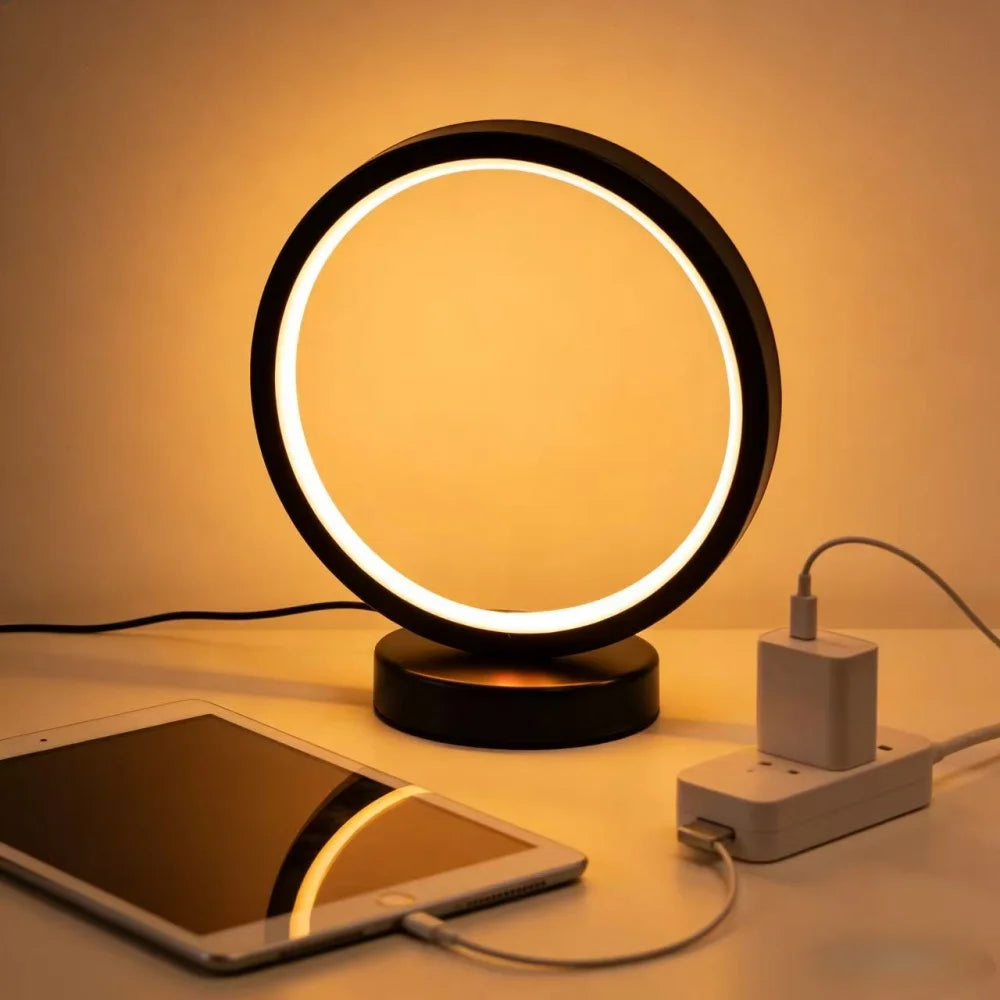 Glow & Drift Eclipse Minimalist Halo Lamp plugged into a USB power strip charging station next to a tablet on a desk