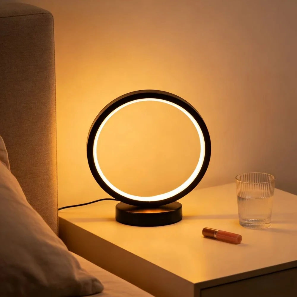 Glow & Drift Eclipse Minimalist Halo Lamp lighting a cozy bedroom nightstand setup with a glass of water