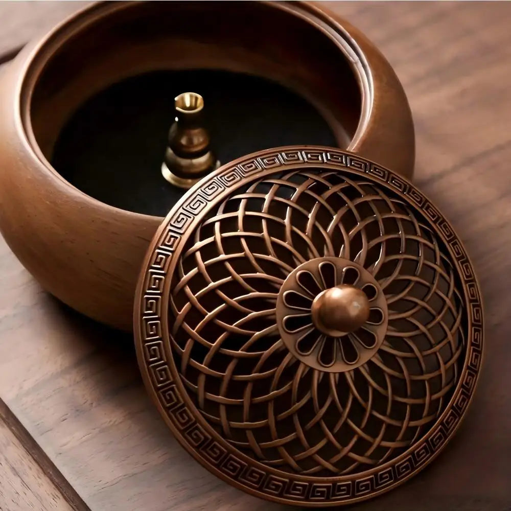 Macro view of the intricately detailed, geometric brass alloy lid leaning against the smooth grain edge of the round wooden incense bowl.