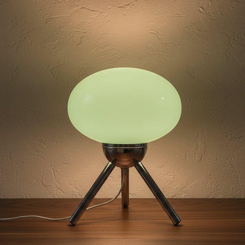 Glow & Drift Alva Bauhaus table lamp with a glowing mushroom glass shade and polished chrome tripod base.