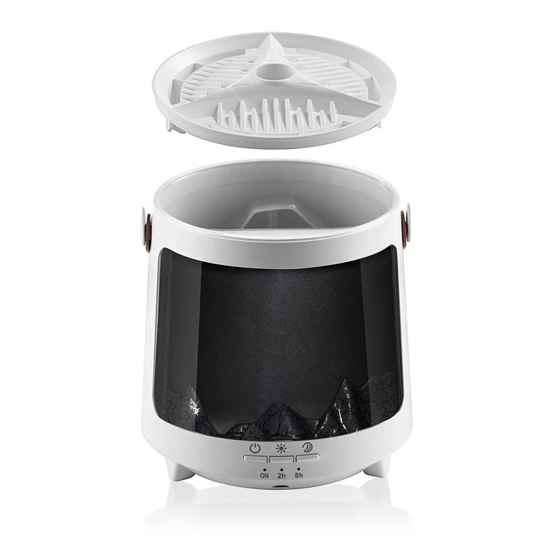 Glow & Drift Aurora Mist & Flame Diffuser with white housing, open lid, and internal mountain landscape design.