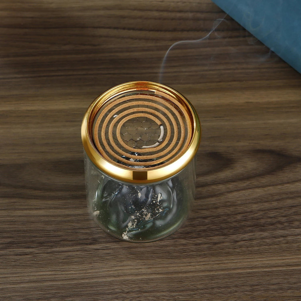 Glow & Drift Azure Peak backflow incense burner with a blue glass mountain, clear cylinder, and golden mesh lid.