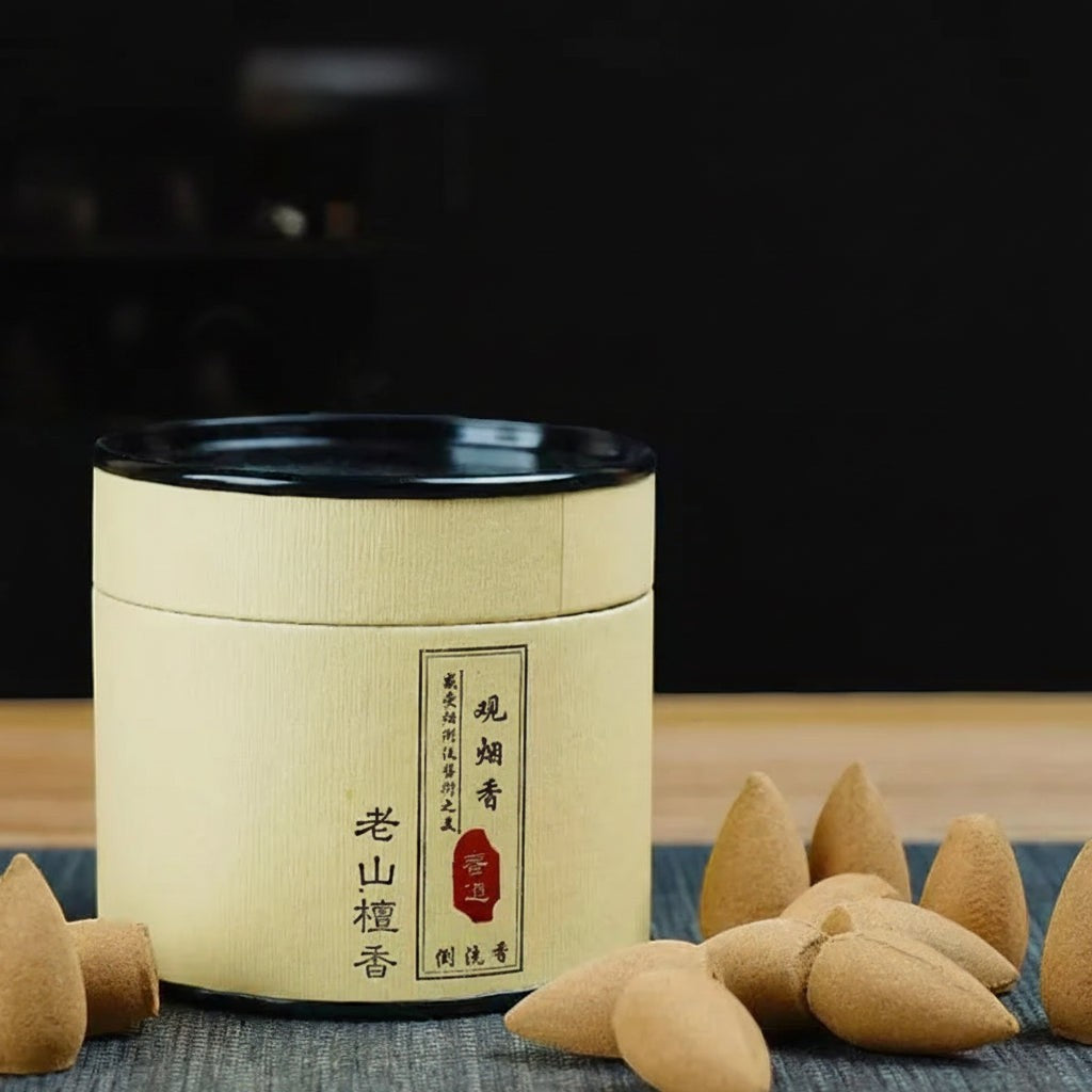 Glow & Drift botanical incense cones in a minimalist cylindrical gift canister for backflow burners.