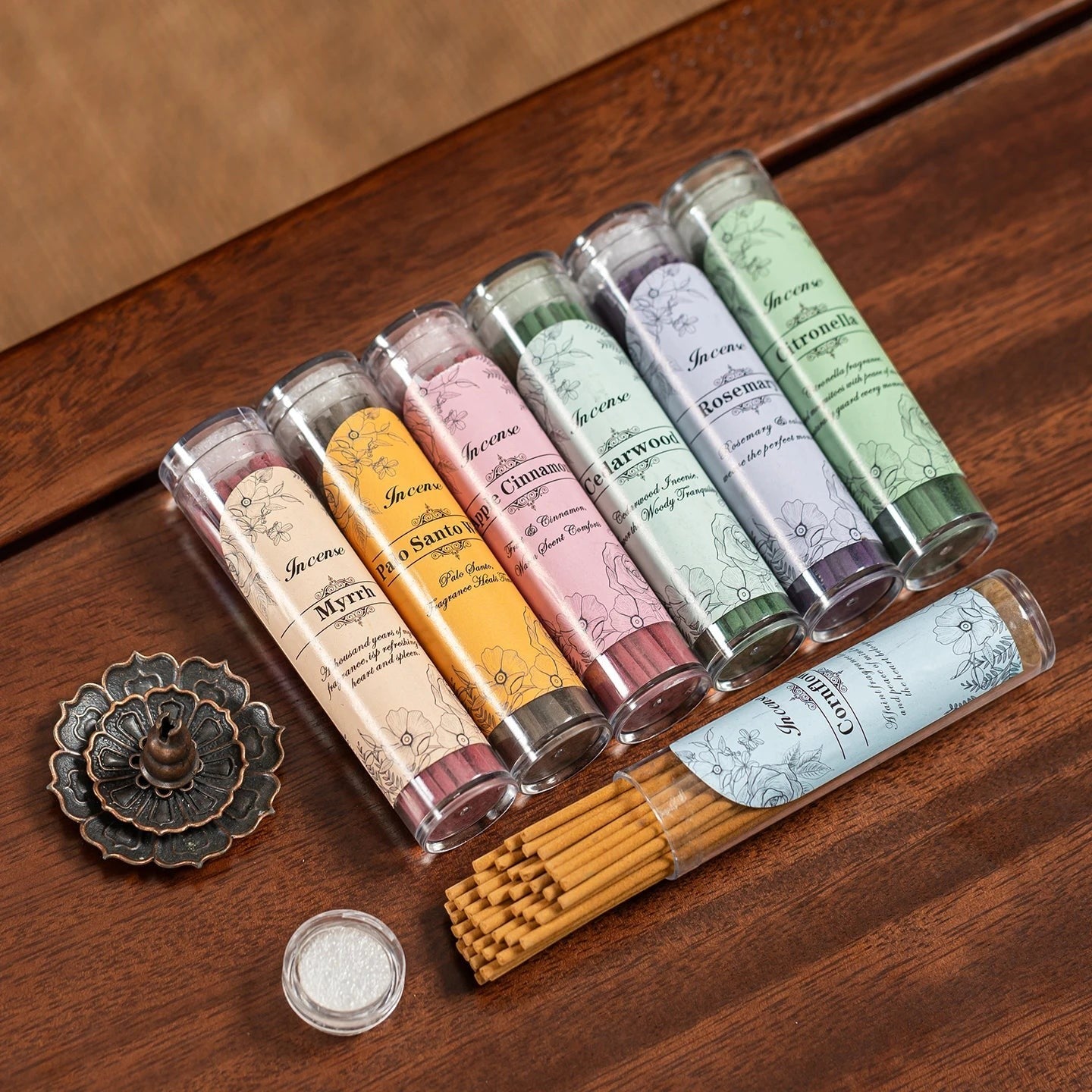 Glow & Drift Botanical Sanctuary incense sticks in various scents with a decorative metal burner on a wooden table.