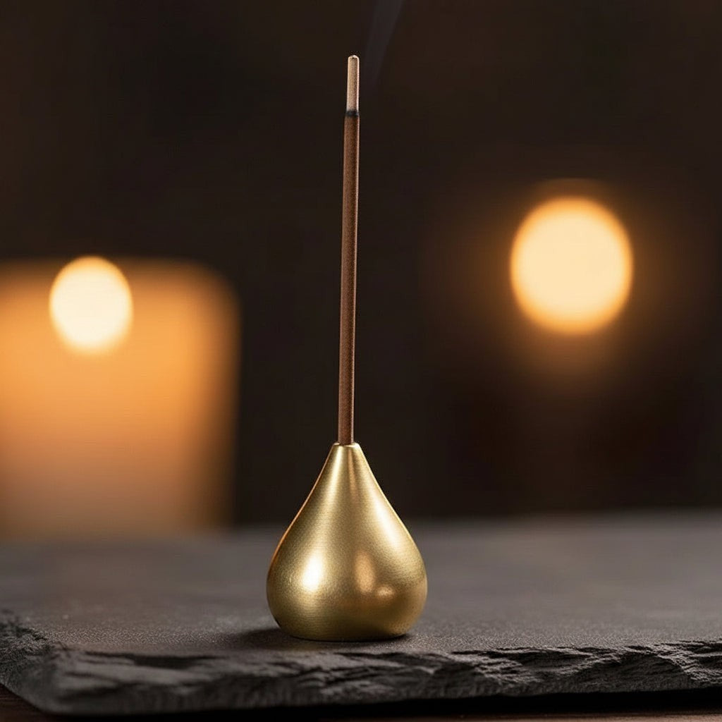Glow & Drift solid copper gourd incense holder with a burning incense stick on a dark slate surface.