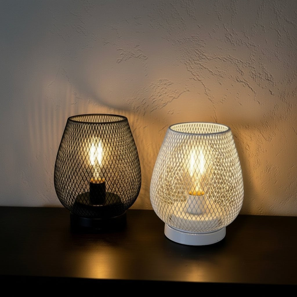 Glow & Drift cordless cage lamps in black and white with warm Edison filament bulbs on a dark surface.