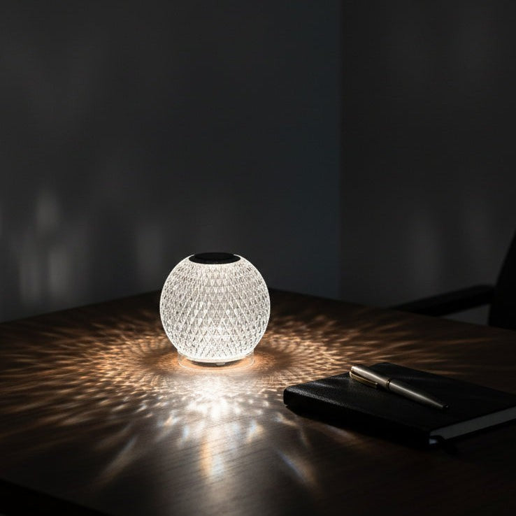 Glow & Drift wireless crystal atmosphere lamp with diamond-cut faceted design casting a patterned light on a table