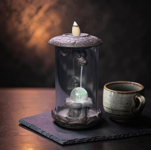 Glow & Drift Aurelian Dragon Glass Tower incense burner with Zisha clay dragon, glass cylinder, and glowing orb.