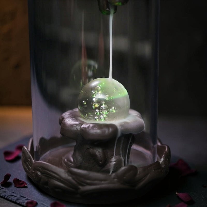 Glow & Drift Aurelian Dragon Glass Tower incense burner with a glowing crystal orb and cascading smoke waterfall.