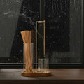 Glow & Drift Solstice Dual Glass Incense Station with wooden base, glass cylinders, and suspended burning incense stick.