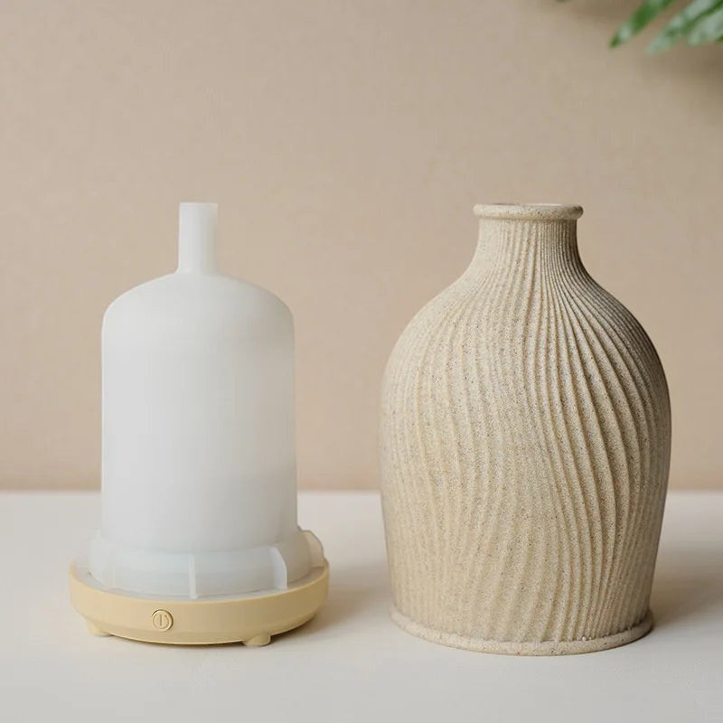 Glow & Drift Earthen Vase Aroma Diffuser with a textured beige resin cover and internal white ultrasonic misting unit.