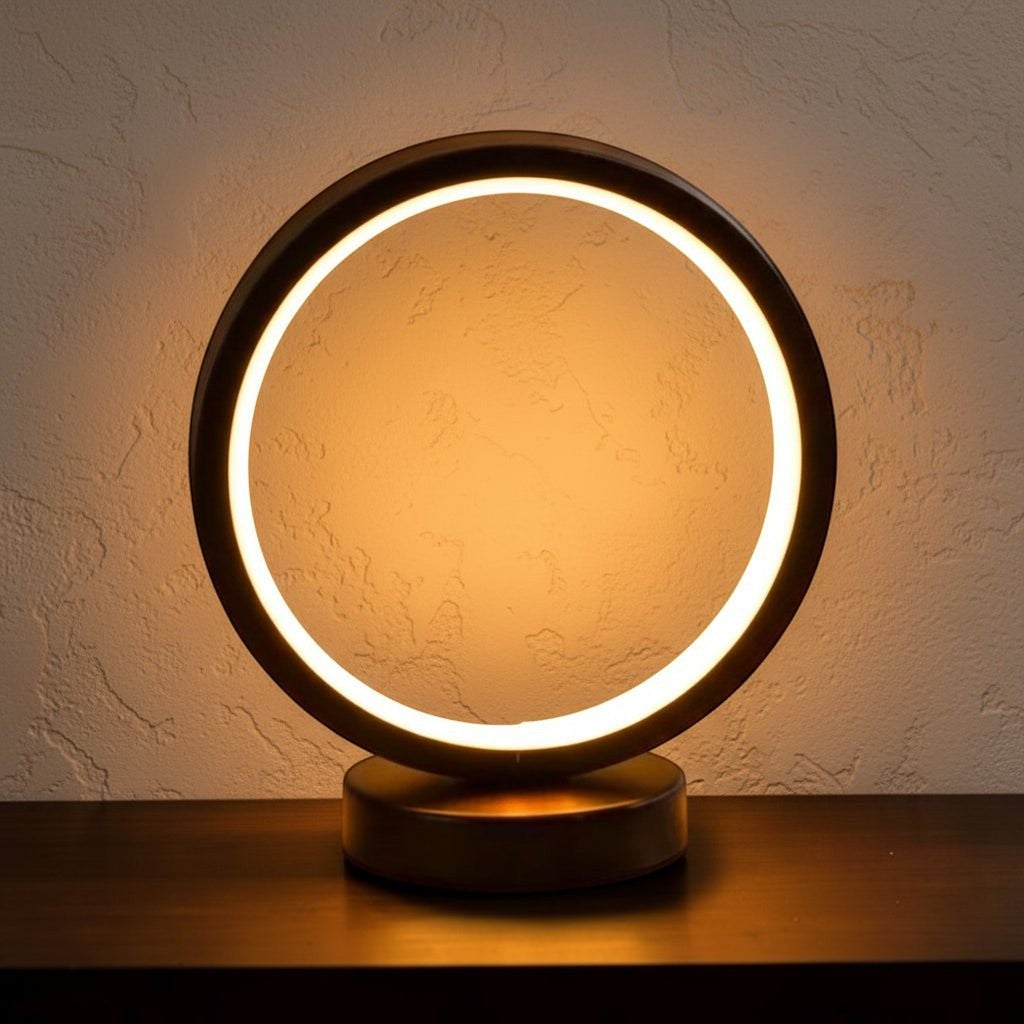 Glow & Drift Eclipse Minimalist Halo Lamp with a matte black circular frame and warm, shadeless LED ambient glow.