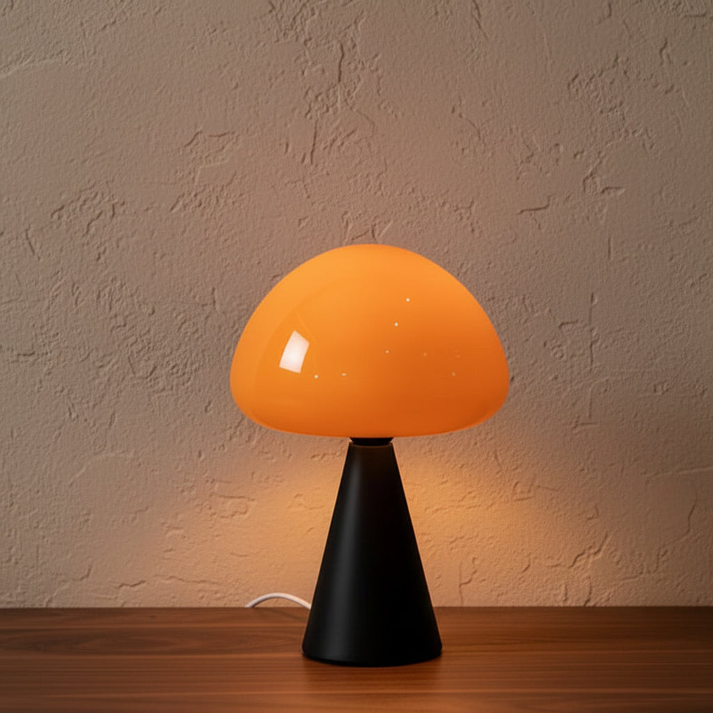 Glow & Drift Eclipse mushroom table lamp with a vibrant orange glass dome and a matte black conical iron base.