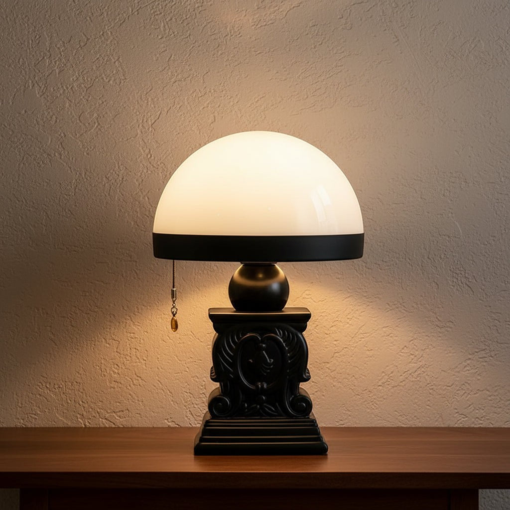 Glow & Drift Elysian cordless table lamp with a black neoclassical carved resin base and a soft-glowing dome shade.