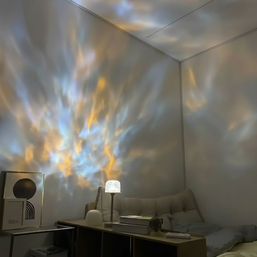 Glow & Drift Ocean Aura Projector Lamp casting dynamic blue and gold water ripple light effects on a bedroom wall