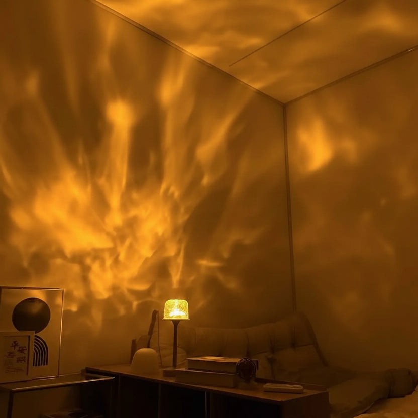 Glow & Drift Ocean Aura Projector Lamp casting warm, dynamic water ripple light effects on a bedroom wall