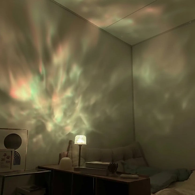 Glow & Drift Ocean Aura Projector Lamp casting a dynamic, multi-colored water ripple effect on a bedroom wall