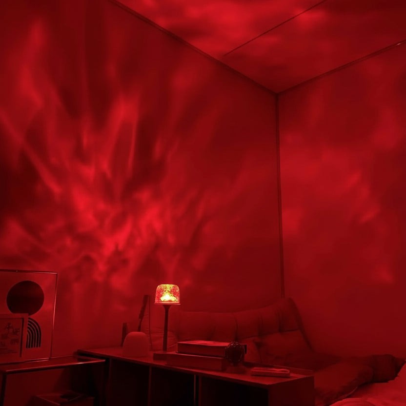 Glow & Drift Ocean Aura projector lamp casting a vibrant red moving water ripple effect on bedroom walls and ceiling