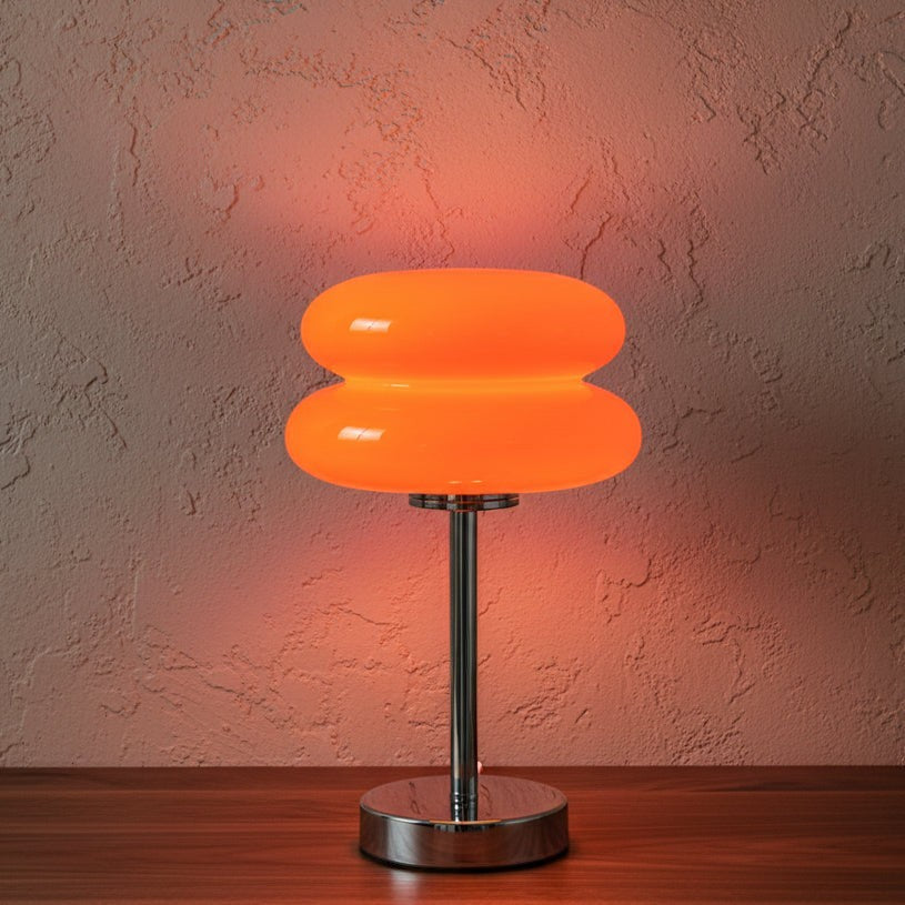 Glow & Drift Retro Macaron glass lamp with a vibrant orange mushroom-shaped shade and polished steel base.