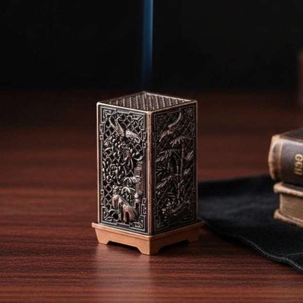 Glow & Drift ornate metal incense tower with intricate hollow-carved patterns and rising smoke on a wooden table.