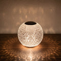 Glow & Drift Prism Crystal Atmosphere Lamp with diamond-cut faceted acrylic casting a warm patterned light on a table.