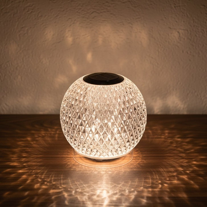 Glow & Drift Prism Crystal Atmosphere Lamp with diamond-cut faceted acrylic casting a warm patterned light on a table.