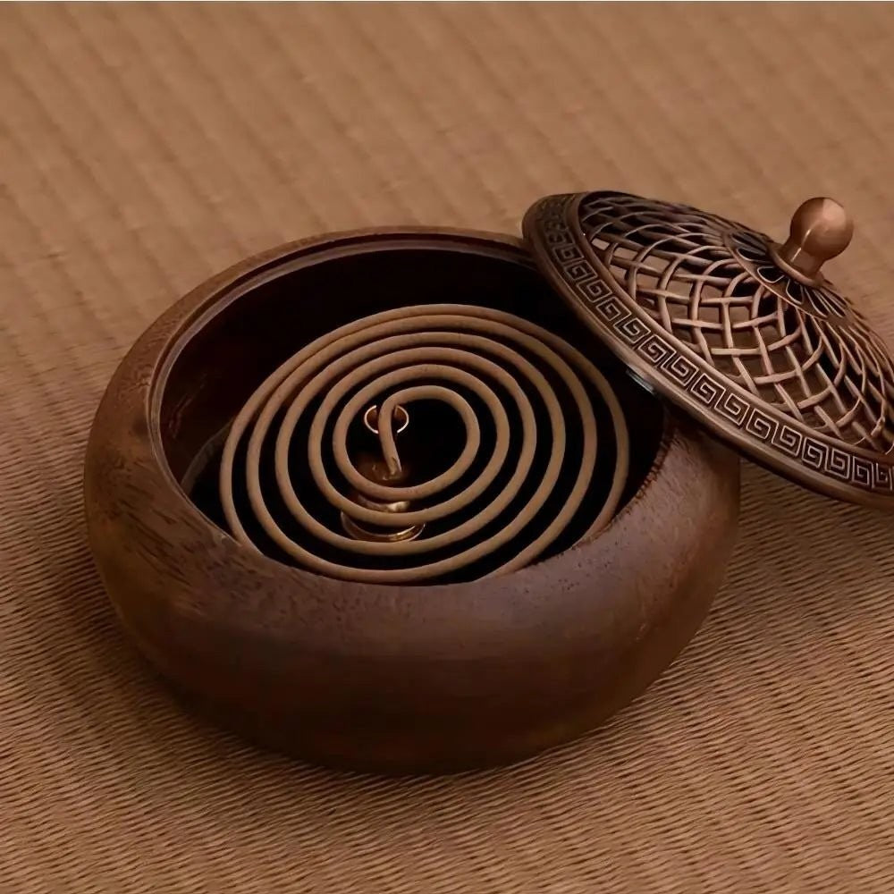 Glow & Drift solid wood incense burner with a round base and an intricate antique-style metal lid holding a coil incense.