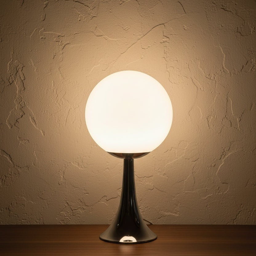 Glow & Drift Solis Glass Globe Lamp with a glowing spherical shade and a polished chrome trumpet-style base.