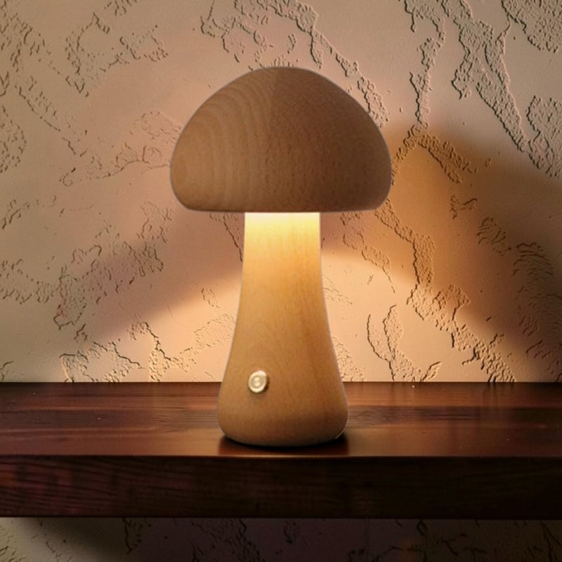 Glow & Drift minimalist mushroom-shaped wooden lamp with a warm, soft LED glow on a dark wooden table.