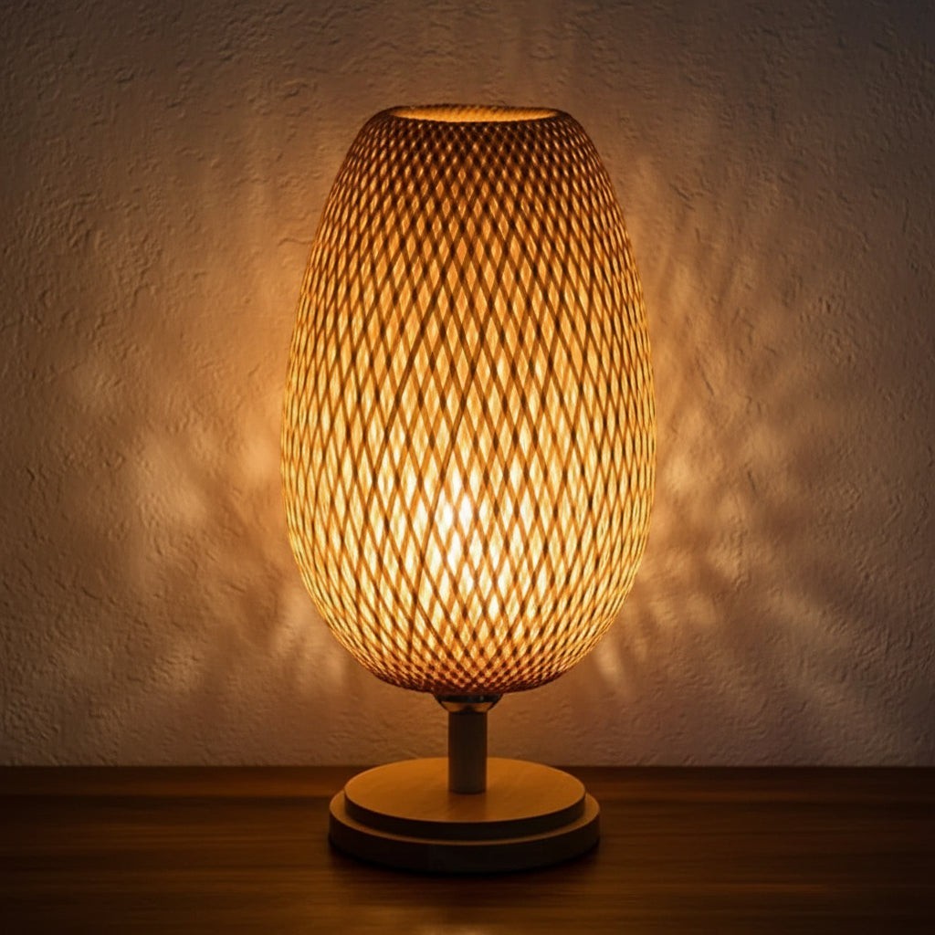 Glow & Drift Woven Canopy Bamboo Lamp with a cocoon-shaped rattan shade on a solid wood base casting warm patterns.