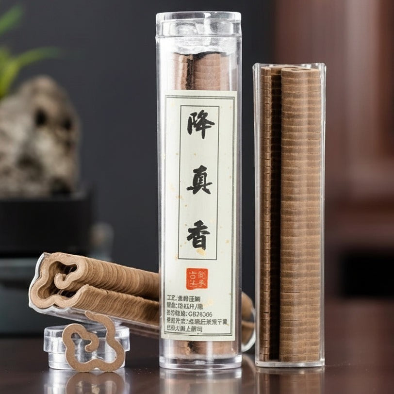 Glow & Drift Xiangyun cloud-shaped natural incense sticks in a clear storage tube on a dark wooden surface.
