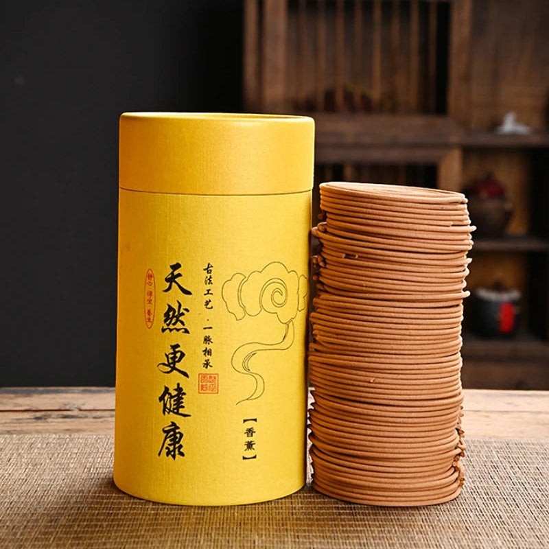Glow & Drift Zenith Ritual Coil Incense set with a yellow storage tube and a stack of natural botanical spiral coils.