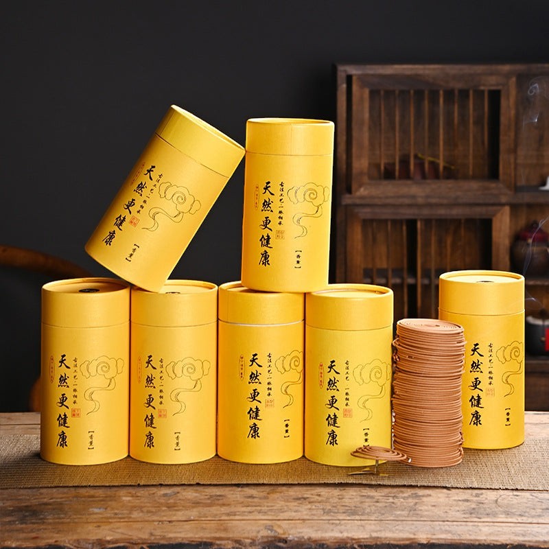 Glow & Drift Zenith Ritual Coil Incense set with yellow cylindrical boxes and a stack of natural botanical incense coils.