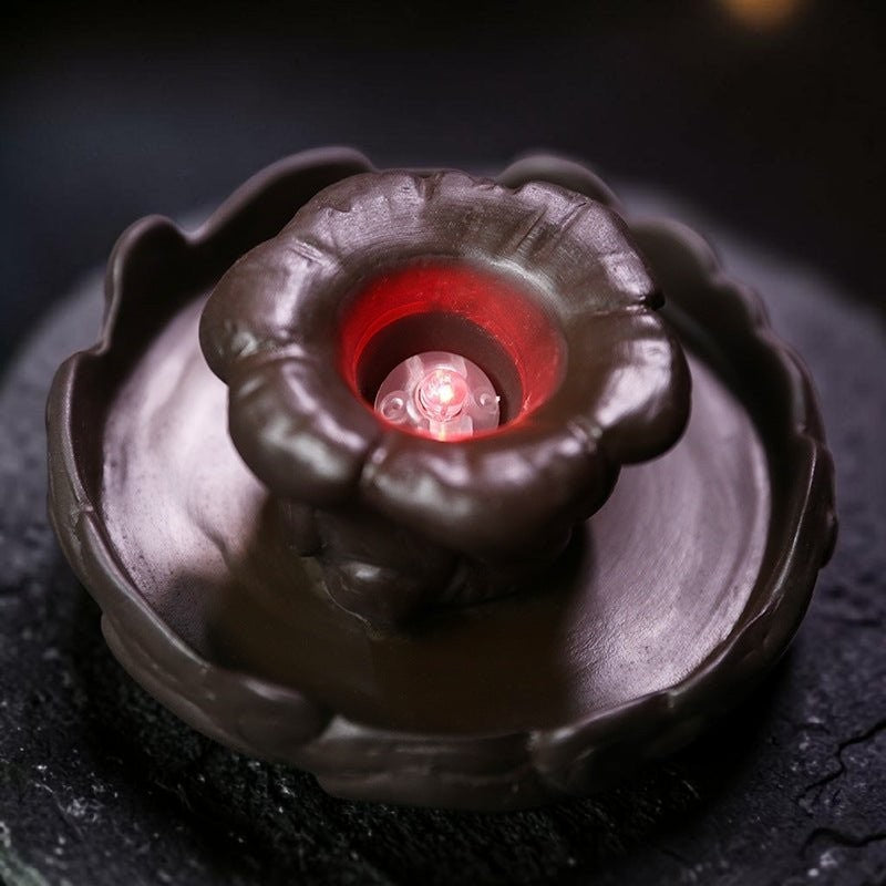 Glow & Drift Aurelian Dragon Glass Tower base featuring a dark Zisha clay lotus leaf with a glowing red crystal orb.