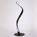 Contemporary serpentine spiral table lamp featuring a luxury matte black finish and a round minimalist base.